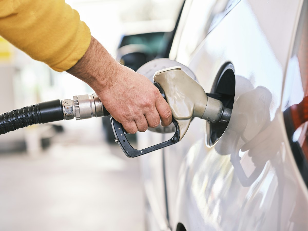 Driver refuelling a car in an illustrative photograph about affordable fuel and energy security